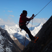 Abseiling down a sheer rock-face